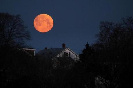 BOSTON, MA - March 20, 2019: - The moon sets over Dorchester neighborhood of Boston, MA on March 20, 2019. (The third supermoon of 2019 on Wednesday isn?t just special because it?s the last supermoon of the year. It?s also the first supermoon in nearly 20 years to fall near the spring equinox. The ?super worm equinox moon,? as it?s known, follows January?s ?super blood wolf moon? and February?s ?super snow moon.? This supermoon will hit its peak at 9:43 p.m. Wednesday, almost four hours after the spring equinox officially hits. This is the first time the two have landed on the same day since March 2000, according to EarthSky.org. Those hoping to catch the supermoon should be in luck: The National Weather Service is predicting mostly clear skies across New England, with clouds increasing as the night goes on.)77(Craig F. Walker/Globe Staff) section: Metro reporter: 
