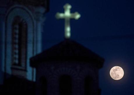A full moon, announcing the end of the winter season, rises over a Church in Skopje, North Macedonia on March 20, 2019. (Photo by Robert ATANASOVSKI / AFP)ROBERT ATANASOVSKI/AFP/Getty Images
