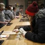 Leicester, MA, 11/19/2018 -- Brittani Beeso, 23, of Worcester purchases marijuana at the opening of Cultivate, one of the state's first two pot shops. This the first day the store can sell recreational marijuana to adults 21 and older. (Jessica Rinaldi/Globe Staff) Topic: 21potopen Reporter: