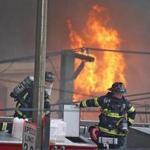 Firefighters battling a massive fire at New England Casket Company on Bennington Street.