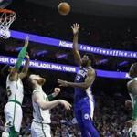 Philadelphia 76ers' Joel Embiid (21) shoots as Boston Celtics' Terry Rozier, from right, Aron Baynes, Marcus Smart and Al Horford watch during the first half of an NBA basketball game, Wednesday, March 20, 2019, in Philadelphia. (AP Photo/Matt Slocum)