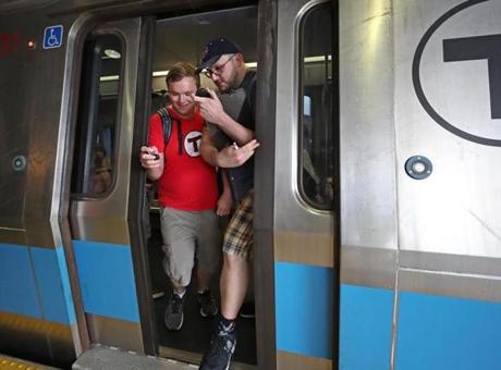 REVERE, MA - 8/18/2017: Squeezing out and foot out before the train doors open are Alex Cox (left) and Dominic DiLuzio as they arrive at Wonderland Station while trying to set a record for visiting every T station on every subway line. . (David L Ryan/Globe Staff ) SECTION: METRO TOPIC 19trecord
