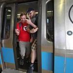 REVERE, MA - 8/18/2017: Squeezing out and foot out before the train doors open are Alex Cox (left) and Dominic DiLuzio as they arrive at Wonderland Station while trying to set a record for visiting every T station on every subway line. . (David L Ryan/Globe Staff ) SECTION: METRO TOPIC 19trecord