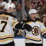 SUNRISE, FL - MARCH 23: Brad Marchand #63 is congratulated by Patrice Bergeron #37 of the Boston Bruins after he scored a second period goal against the Florida Panthers at the BB&T Center on March 23, 2019 in Sunrise, Florida. (Photo by Joel Auerbach/Getty Images)