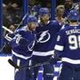 Tampa Bay Lightning center Steven Stamkos (91) celebrates his goal against the Boston Bruins with defenseman Victor Hedman (77) and defenseman Mikhail Sergachev (98) during the first period of an NHL hockey game Monday, March 25, 2019, in Tampa, Fla. (AP Photo/Chris O'Meara)