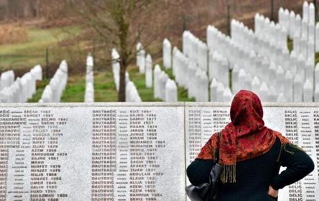A Bosnian Muslim woman, walks by the memorial wall containing the names of the victims at the Srebrenica memorial in Potocari, on March 20, 2019, on the day of the final sentence handed down in the case of Bosnian Serb wartime leader Radovan Karadzic before the Mechanism for International Criminal Tribunals (MTPI) in The Hague. - Former Bosnian Serb leader Radovan Karadzic will spend the rest of his life in jail for the 