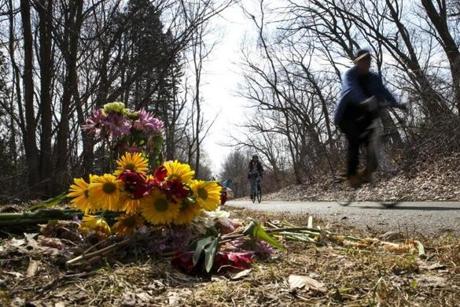 Cyclists rode Saturday past a memorial placed at the site of an accident on the Minuteman Bikeway in Lexington last Sunday.
