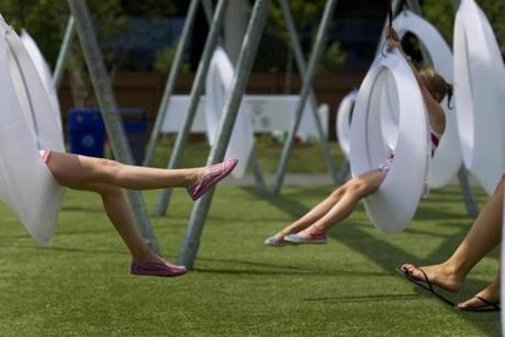 7/30/2015 - South Boston, MA - Lawn on D - The McKeigue sisters (Mia, Libby and Georgie, cq) spent a hot, hazy afternoon swinging on the rings with their nanny Jackie Hixon, cq, at the Lawn on D in South Boston on Thursday, July 30, 2015. Photo by Dina Rudick/Globe Staff.
