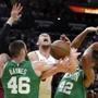 Miami Heat forward Kelly Olynyk, center, is fouled by Boston Celtics center Aron Baynes (46), who defends along with center Al Horford (42) during the first half of an NBA basketball game Wednesday, April 3, 2019, in Miami. (AP Photo/Lynne Sladky)