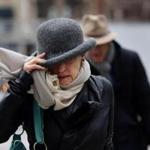 A woman protected herself from the wind while passing through Copley Square on Wednesday. 