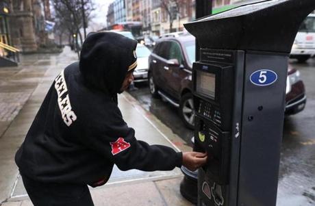 BOSTON, MA - 1/03/2017: Clayton Johnson (cq) from Dorchester pays the meter on Newbury Street....In Boston the new pilot parking rates on meters goes into effect in Back Bay and Seaport areas (David L Ryan/Globe Staff Photo) SECTION: METRO TOPIC 04parking
