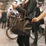 Young woman using mobile phone being robbed by a pickpocket at the subway station. Pickpocketing at subway station