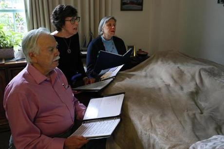 The Threshold Singers choir sat at the bedside of a dying patient and sang to him. Pictured, from left to right: Richard Friday, Patty Fraser, and Fran Hunt.
