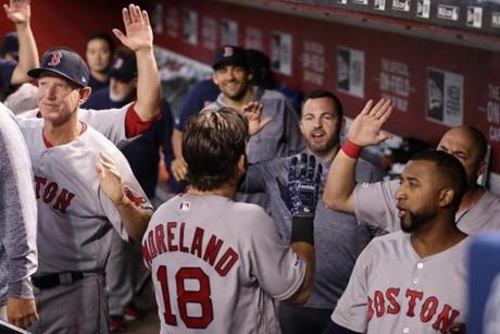 PHOENIX, ARIZONA - APRIL 07: Mitch Moreland #18 of the Boston Red Sox high fives teammates in the dugout after hitting a solo home run against the Arizona Diamondbacks during the seventh inning of the MLB game at Chase Field on April 07, 2019 in Phoenix, Arizona. (Photo by Christian Petersen/Getty Images)
