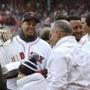 Former Boston Red Sox star Manny Ramirez, left, holds the World Series trophy beside Pedro Martinez, second from right, and David Ortiz, right, before the home opener baseball game between the Red Sox and the Toronto Blue Jays, Tuesday, April 9, 2019, in Boston. (AP Photo/Charles Krupa)