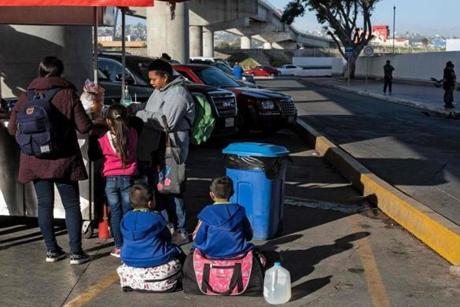 Asylum seekers eat outside El Chaparral port of entry as they wait for a turn to present themselves to US border authorities to request asylum, in Tijuana, Baja California state, Mexico, on April 9, 2019. - A US federal judge on Monday blocked President Donald Trump's policy of returning asylum seekers to Mexico to wait out the processing of their cases, saying the Department of Homeland Security had overstepped its authority. (Photo by Guillermo Arias / AFP)GUILLERMO ARIAS/AFP/Getty Images
