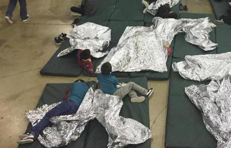 Ina photo from June 2018, people who?d been taken into custody related to cases of illegal entry into the United States, rested in one of the cages at a facility in McAllen, Texas. 
