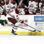 FILE - In this Saturday, Jan. 12, 2019 file photo, UMass Amherst defenseman Cale Makar (16) reaches for the puck with Vermont forward Vlad Dzhioshvili (10) close behind during a NCAA hockey game in Amherst, Mass. Defenseman Cale Makar cited loyalty in sticking to his commitment to play at Massachusetts despite a coaching change. Two years later, Makar is a Hobey Baker finalist and has the Minutemen (30-9) preparing to make their first Frozen Four appearance. UMass will face Denver, while Providence is playing Minnesota Duluth in the semifinals on Thursday, April 11, 2019.(AP Photo/Scott Eisen, File)