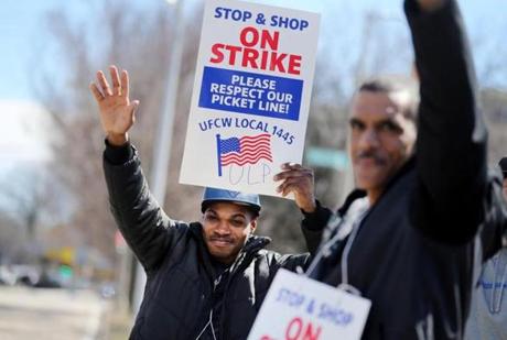 Stop and Shop employee Jeff Jean-Louis held a strike placard while waving to traffic outside the the Stop and Shop on Freeport St. in Dorchester. 
