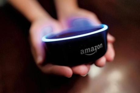 In this Thursday, Aug. 16, 2018, photo a child holds his Amazon Echo Dot in Kennesaw, Ga. Amazon updated its voice assistant with a feature that can make Alexa more kid-friendly. When the FreeTime feature is activated, Alexa answers certain questions differently. (AP Photo/Mike Stewart)
