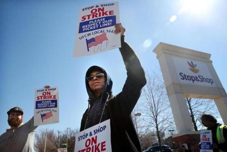  BOSTON, MA - April 11, 2019: - Stop and Shop employee Luis Medina holds a strike placard while waving to traffic outside the the Stop and Shop on Freeport St. in Dorchester, Boston, MA on April 11, 2019. (Craig F. Walker/Globe Staff) section: Metro reporter:

