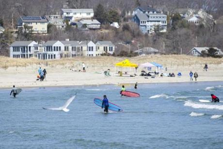 Gloucester, MA--04/06/2019--Surfers enjoy the nice weather on Good Harbor Beach in Gloucester, MA during the Lake Atlantic Invitational hosted by the UMass Amherst Surf Club on Saturday afternoon. on Saturday afternoon. (Nathan Klima for The Boston Globe) Topic: 07surfpic Reporter:
