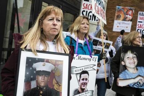 CAMBRIDGE, MA - 04/12/2019 Kathleen Scarpone holds a photo of her son, Sgt. Joseph Scarpone, during a demonstration outside of the Arthur M Sackler Museum where parent?s of opiod victims demand the removal of the Sackler name from any public space. Scarpone, of Kingston, NH, lost her son one month shy of his 26th birthday in 2016. (Erin Clark for The Boston Globe)
