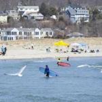 Gloucester, MA--04/06/2019--Surfers enjoy the nice weather on Good Harbor Beach in Gloucester, MA during the Lake Atlantic Invitational hosted by the UMass Amherst Surf Club on Saturday afternoon. on Saturday afternoon. (Nathan Klima for The Boston Globe) Topic: 07surfpic Reporter: