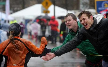 Newton, MA- April 16, 2018: (left to right) Bobby Looney and Justin Mundt and offer encouragement as they crest Heartbreak Hill during the Boston Marathon in Newton, MA on April 16, 2018. (Craig F. Walker/Globe Staff) section: sports reporter:
