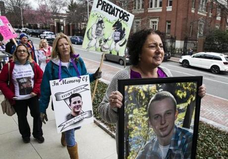 CAMBRIDGE, MA - 04/12/2019 Nancy Tobin, far right, walks ahead of national advocacy groups made up of parents who have lost a child to opioid overdose as they march outside of the Arthur M Sackler Museum at a protest to demand removal of the Sackler name from any public space. Tobin lost her 22-year-old son, Scott, to an overdose in 2017. (Erin Clark for The Boston Globe)
