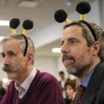 Judges Will Johnston (left) and Peter Chipman got in the spirit of Thursday?s corporate spelling bee.
