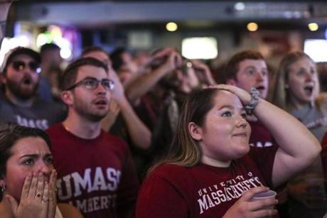 Amherst, MA--04/13/2019--UMass Amherst students watching the Frozen Four championship game at Spoke on Saturday night react to the impeding loss during the last seconds of the game. (Nathan Klima for The Boston Globe) Topic: 14amherst Reporter:
