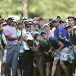 Tiger Woods hits from the gallery along the 11th fairway during the third round of the Masters golf tournament Saturday, April 13, 2019, at Augusta National in Augusta, Ga. (Curtis Compton/Atlanta Journal-Constitution via AP)