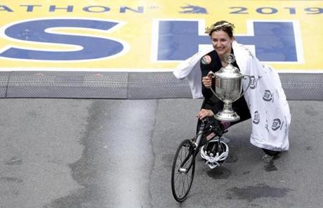 MARATHON SLIDER Boston, MA, 04/15/2019 -- Women's wheelchair Manuela Schar poses for a photo with the trophy at the Finish Line of the 123rd Boston Marathon. (Jessica Rinaldi/Globe Staff) Topic: 16marathonphotos Reporter: 
