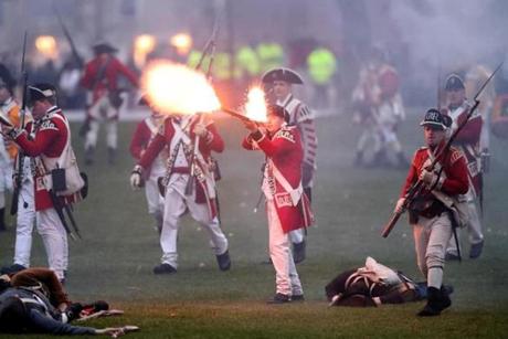 APRIL 15, 2019 --LEXINGTON, MA - Lexington Minute Men lie dead and wounded on ground as Her Majesty's Army fires their mustkets as re-enactors depict the skirmish that took place on Lexington common early on the morning of April 19, 1775. (Joanne Rathe/ Globe Staff) 
