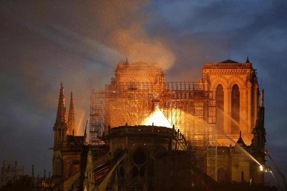 Flames billowed from the roof of Notre Dame Cathedral.