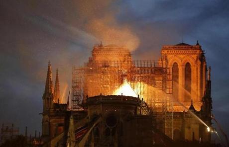 Firefighters attacked flames burning through Notre Dame Cathedral.

