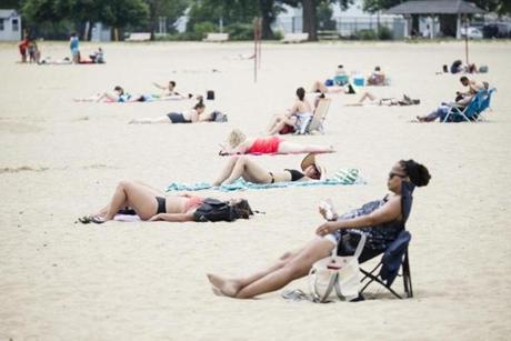 People lay out in the sun on Boston?s Carson Beach in the summer of 2018. 
