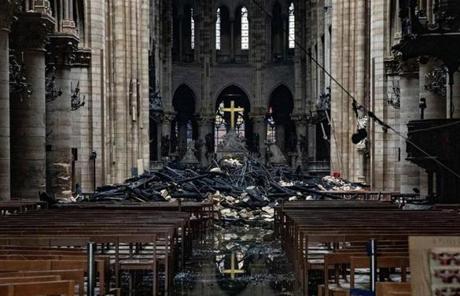 Cathedral SLIDER Fire damaged wood and stone sits near the altar inside Notre Dame Cathedral in Paris on April 16, 2019. MUST CREDIT: Bloomberg photo by Christophe Morin.

