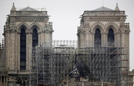 Cathedral SLIDER View of the scaffolding and damaged Notre Dame cathedral after the fire in Paris, Tuesday, April 16, 2019. Experts are assessing the blackened shell of Paris' iconic Notre Dame cathedral to establish next steps to save what remains after a devastating fire destroyed much of the almost 900-year-old building. With the fire that broke out Monday evening and quickly consumed the cathedral now under control, attention is turning to ensuring the structural integrity of the remaining building. (AP Photo/Christophe Ena)
