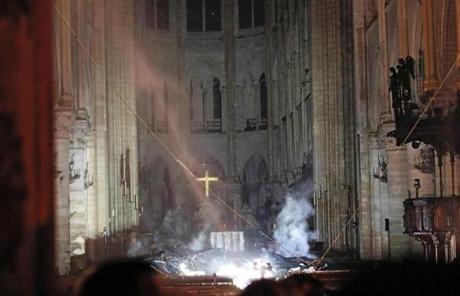 Cathedral SLIDER Smoke rises in front of the altar cross at Notre-Dame Cathedral in Paris on April 15, 2019, after a fire engulfed the building. - A fire broke out at the landmark Notre-Dame Cathedral in central Paris, potentially involving renovation works being carried out at the site, the fire service said.Images posted on social media showed flames and huge clouds of smoke billowing above the roof of the gothic cathedral, the most visited historic monument in Europe. (Photo by PHILIPPE WOJAZER / POOL / AFP)PHILIPPE WOJAZER/AFP/Getty Images
