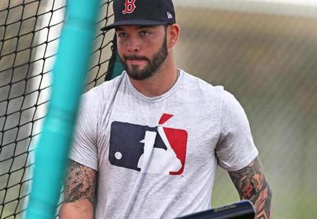Fort Myers, FL 2/13/2018: Red Sox catcher Blake Swihart (right) is pictured as he heads into a batting cage to hit as teamate and fellow backstop Sandy Leon (left) heads out during a batting practice session at the Player Development Complex at Jet Blue Park. (Jim Davis/Globe Staff)
