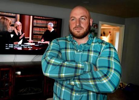 East Freetown 04/05/19 : Nick Memmo (cq) in the living room area of his East Freetown home. Memmo mistakenly received a 86 inch screen tv along with the 74 inch (behind him) he ordered from Amazon. He was later arrested on charges of larceny.Photo for the Boston Globe by Debee Tlumacki (metro)
