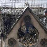 Damage on the facade at the Notre Dame Cathedral, in Paris, Wednesday, April 17, 2019. Nearly $1 billion has already poured in from ordinary worshippers and high-powered magnates around the world to restore Notre Dame Cathedral in Paris after a massive fire. (AP Photo/Christophe Ena)