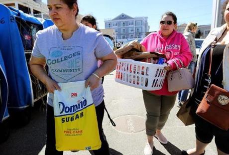 Rubidia Escobar (right) and Ofelia Duarte carried groceries at the Hyannis Ferry Terminal bought at Market Basket in Bourne.
