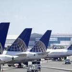 FILE - In this July 18, 2018, file photo, United Airlines commercial jets sit at a gate at Terminal C of Newark Liberty International Airport in Newark, N.J. The grounding of its Boeing 737 Max jets is causing United Airlines to trim growth plans for this year, and the carrier expects to discuss potential compensation with Boeing. (AP Photo/Julio Cortez, File)