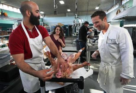 4-17-19: Danvers, MA: Chris Keohane, (right), the owner of the Fresh Food Culinary Center, chef Nicholas Escoto (left) and owner Sam Kanter (center) are pictured during the preparation of the food for 