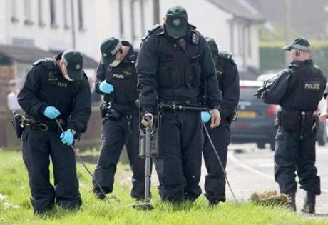 Police officers searched near the scene in the Creggan area of Derry where journalist Lyra McKee was fatally shot.

