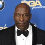 Director John Singleton is in intensive care after he suffered a stroke, his family says.