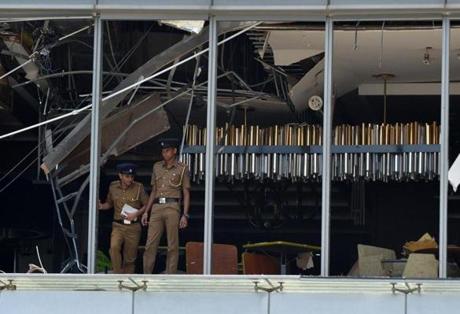 Sri Lankan police inspected the blown-out Shangri-La hotel in Colombo on Sunday.
